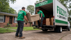 junk removal cost Memphis — Fuzzy's crew loading household junk into a truck after giving an upfront quote