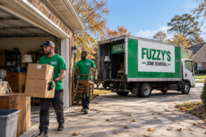 Fuzzy's crew carrying furniture and boxes out of a garage during a Memphis fall cleanout